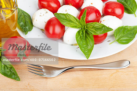 Caprese salad plate on wooden table