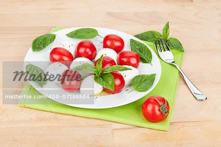 Caprese salad plate on wooden table