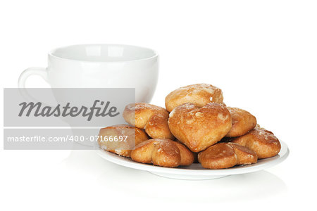 Various cookies in bowl and tea cup. Isolated on white background