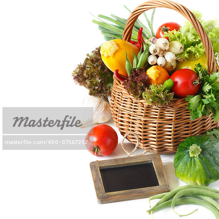 Fresh vegetables and chalk blackboard for text on a white background.