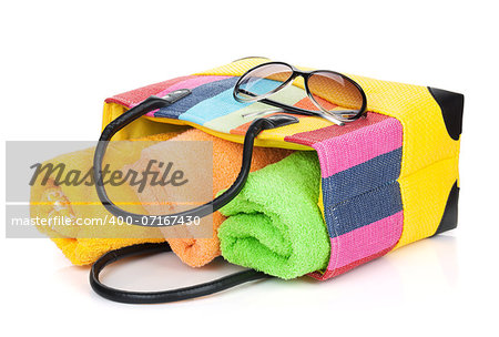 Beach bag with towels and sunglasses. Isolated on white background