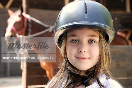 Portrait of little girl and brown Horse