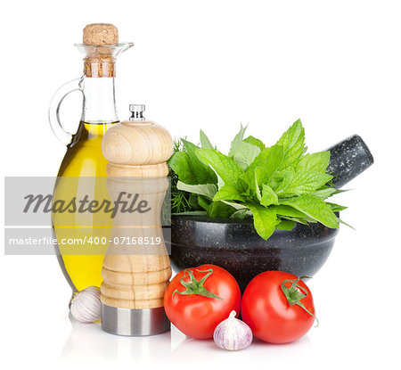 Fresh herbs, olive oil and pepper shaker. Isolated on white background