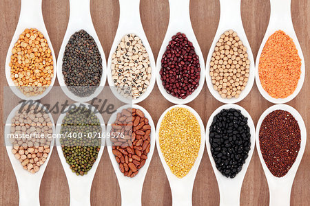 Dried pulses food selection in white porcelain spoons.