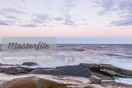 Waves crashing the ocean shore at crack of dawn (Cape Breton, Nova Scotia, Canada)