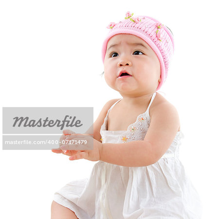 Portrait of cute Asian baby girl looking up,  isolated on white background