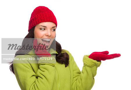 Beautiful Mixed Race Woman Wearing Winter Hat and Gloves Isolated on a White Background Gesturing with Her Hand to the Side.