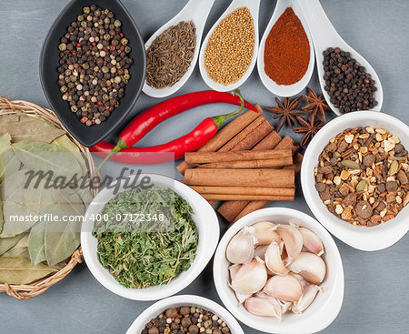 Colorful herbs and spices selection. Aromatic ingredients on wood table