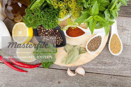 Herbs and spices on cutting board and wood table