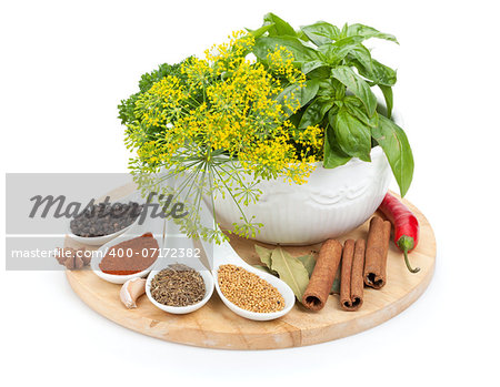Colorful herbs and spices selection. Seasoning and aromatic ingredients on cutting board. Isolated on white background