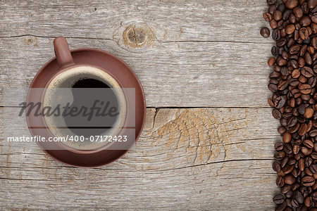 Coffee cup on wooden table texture with copy space. View from above