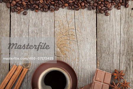 Coffee cup, spices and chocolate on wooden table texture with copy space. View from above