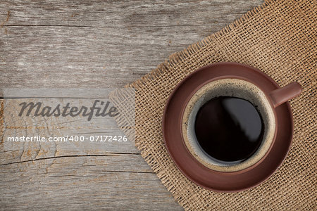 Coffee cup on wooden table texture. View from above