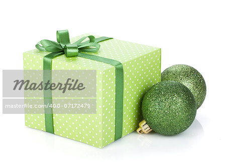 Gift box with ribbon and bow and christmas baubles. Isolated on white background