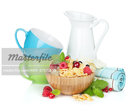 Fresh corn flakes with berries and milk. Isolated on white background