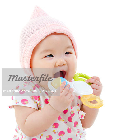 Beautiful mixed race Asian baby girl teething, biting with her toys, isolated on white background.