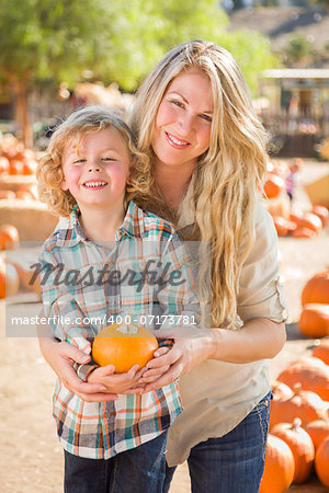 Attractive Mother and Son Portrait in a Rustic Ranch Setting at the Pumpkin Patch.