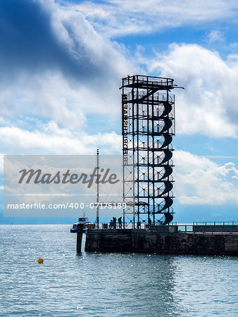 At the edge of the lake Bodensee with view to a belvedere in the town Friedrichshafen, Germany