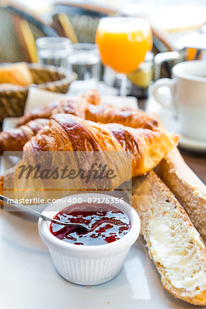 Breakfast with coffee and croissants on table