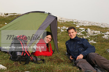 Two young people camping in the mountains alps