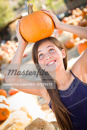 Preteen Girl Portrait at the Pumpkin Patch in a Rustic Setting.