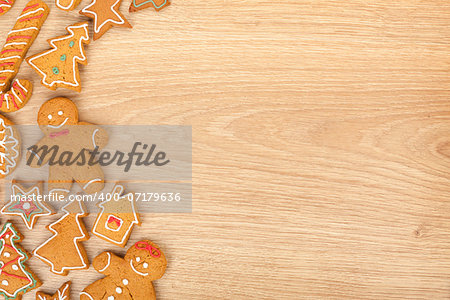 Homemade various christmas gingerbread cookies on wooden background with copy space