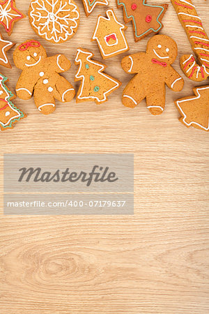 Homemade various christmas gingerbread cookies on wooden background with copy space