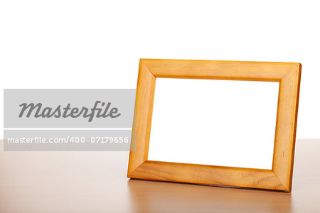 Photo frame on wood table. Isolated on white background