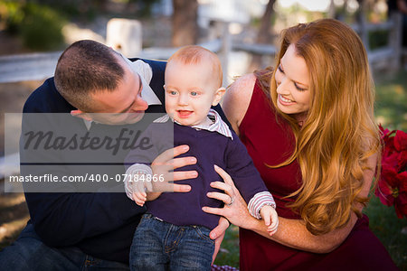 Adorable Infant Boy and Young Military Parents Play Together in the Park.