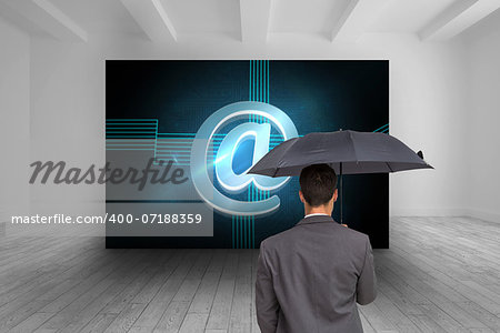 Composite image of rear view of classy businessman holding grey umbrella