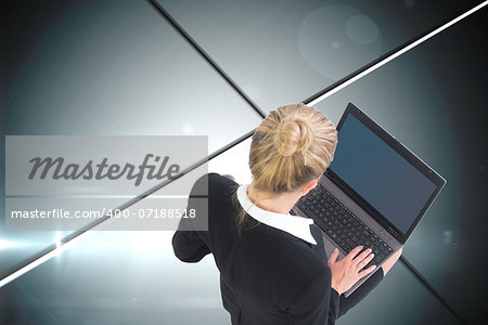 Composite image of blonde businesswoman using laptop