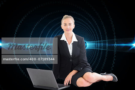 Composite image of blonde businesswoman using laptop