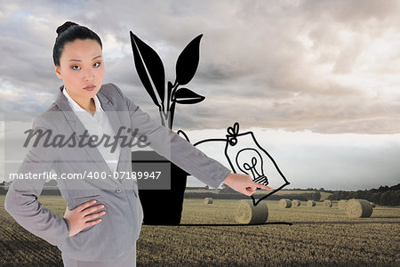 Composite image of unsmiling asian businesswoman pointing