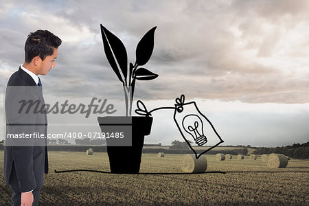 Composite image of unsmiling businessman looking down