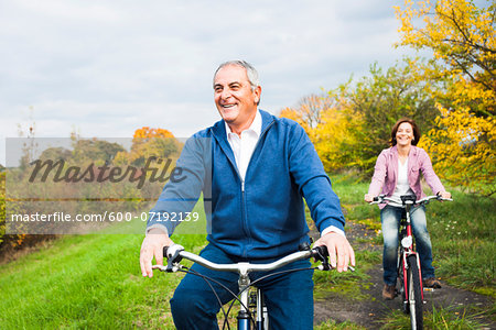 Couple Riding Bicycles in Autumn, Mannheim, Baden-Wurttemberg, Germany
