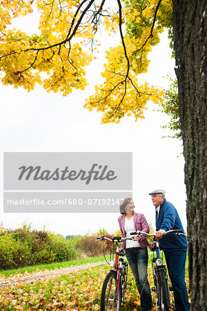 Couple Standing by Tree with Bicycles, Mannheim, Baden-Wurttmeberg, Germany