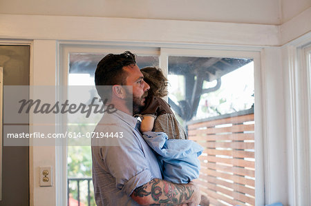 Side view of father holding toddler