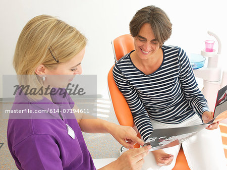 Patient looking at brochure for dental implants