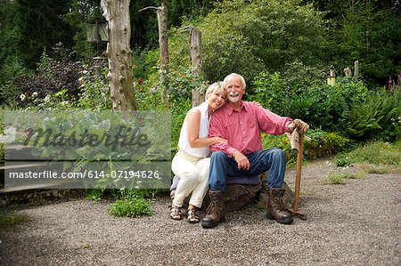 Portrait of senior couple sitting in garden