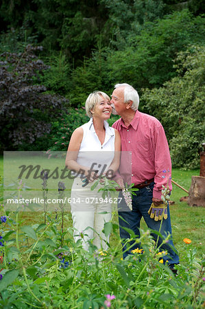 Portrait of senior couple sharing a kiss in garden