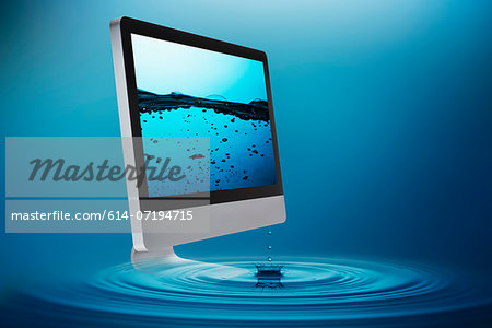 Still life with computer submerging in water