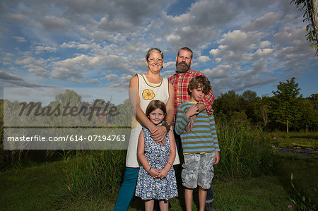Portrait of couple with children on family herb farm Portrait of couple with children on family herb farm