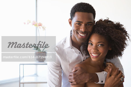 Portrait of young couple, man with arm around woman