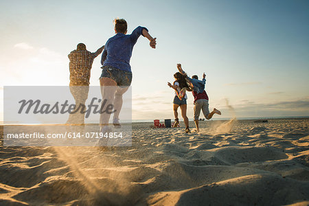 Friends running on Mission Beach, San Diego, California, USA