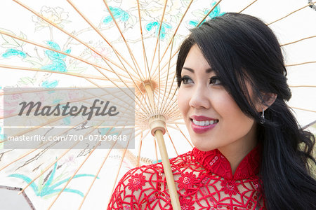 Close-up portrait of young woman holding Chinese parasol, Ontario, Canada