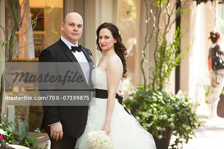 Portrait of bride and groom standing in hallway, Ontario, Canada