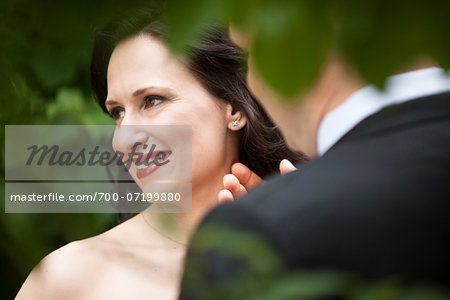 Close-up portrait of bride and groom, standing outdoors, Ontario, Canada