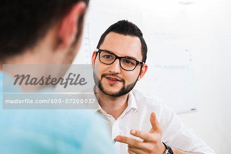 Close-up of two young businessmen meeting and in discussion, Germany