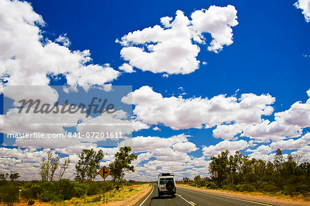 Four-wheel-drive vehicle on road in the Red Centre, Australia