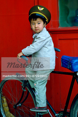 Young boy playing on a bicycle, Beijing, China